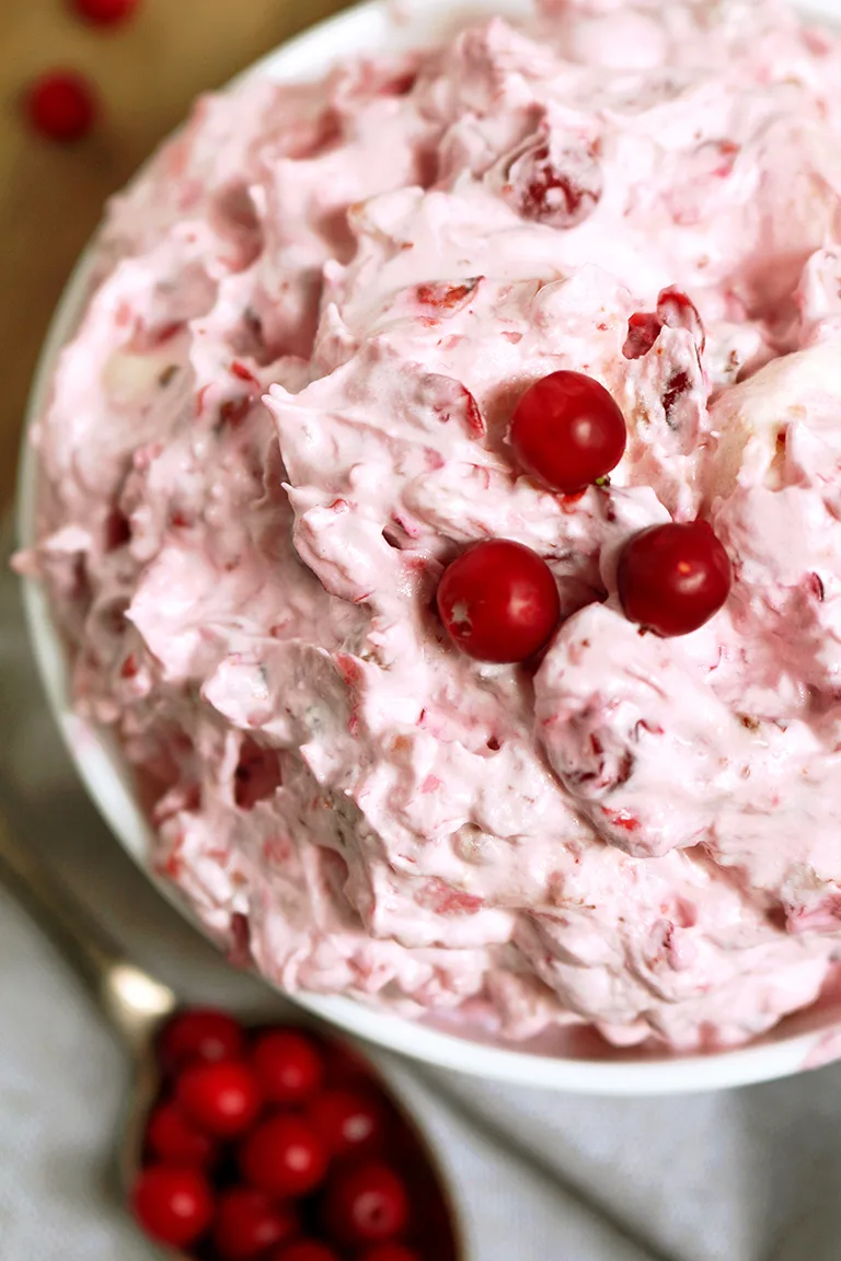 This salad is a perfect dessert for Thanksgiving Dinner or New Year‘s Eve feast. Cranberry Cheesecake Fluff Salad is quick, simple and easy to prepare.