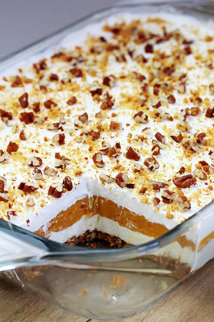 Pumpkin Lush – this fast-made, light, yet delicious creamy dessert, with cheese cream and pumpkin layers, and gingersnap cookie crust, topped with chopped pecans and gingersnap cookie crumbs, will delight all the pumpkin lovers