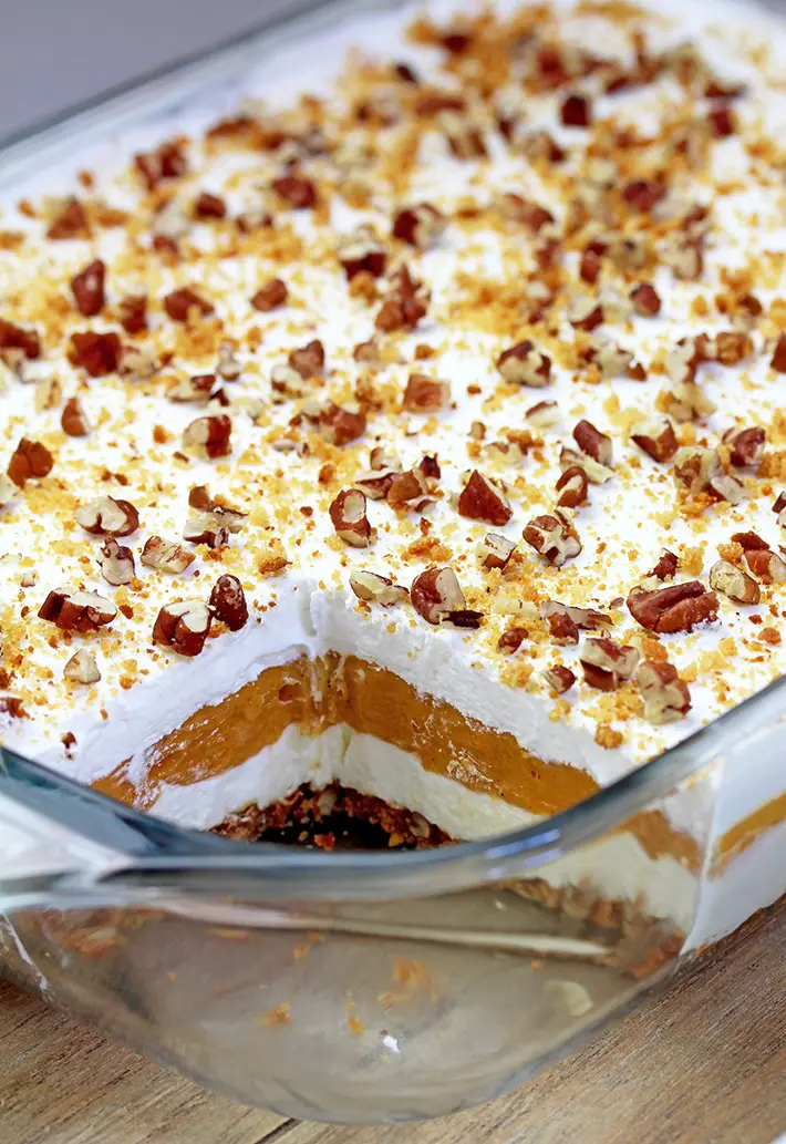 Pumpkin Lush – this fast-made, light, yet delicious creamy dessert, with cheese cream and pumpkin layers, and gingersnap cookie crust, topped with chopped pecans and gingersnap cookie crumbs, will delight all the pumpkin lovers