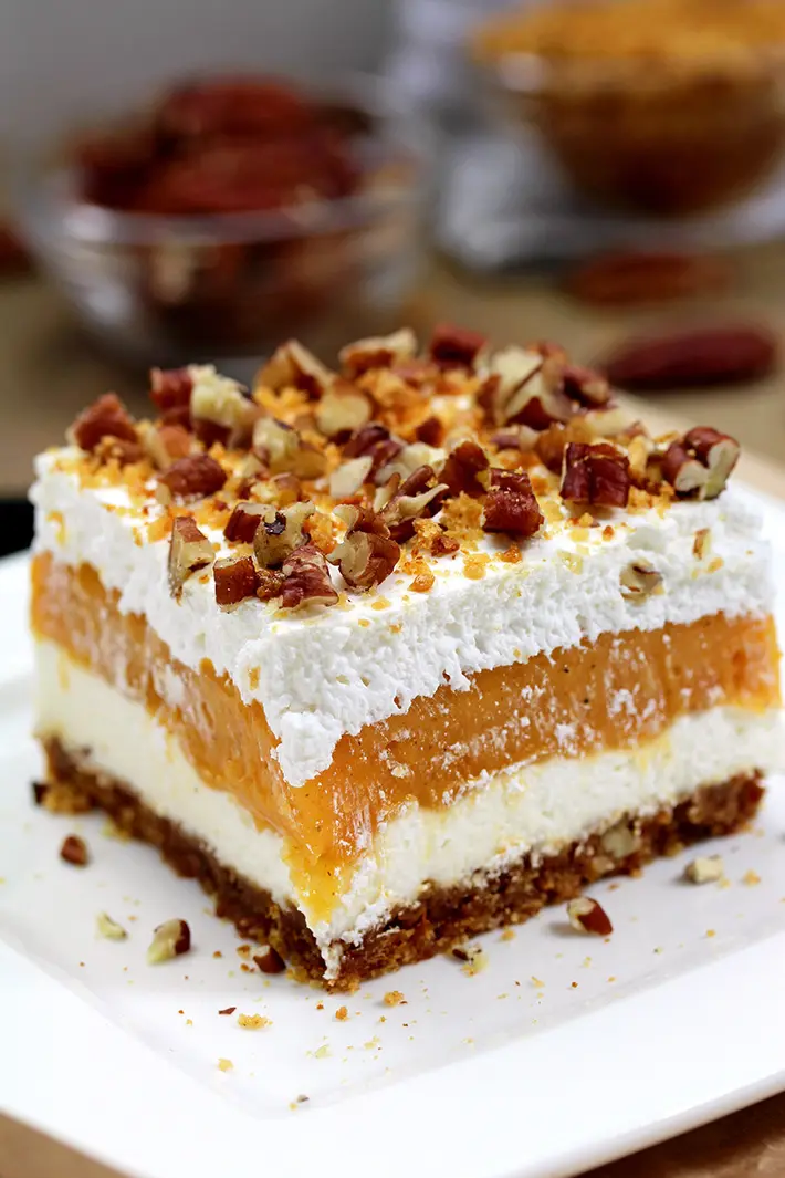 Pumpkin Lush – this fast-made, light, yet delicious creamy dessert, with cheese cream and pumpkin layers, and gingersnap cookie crust, topped with chopped pecans and gingersnap cookie crumbs, will delight all the pumpkin lovers. 