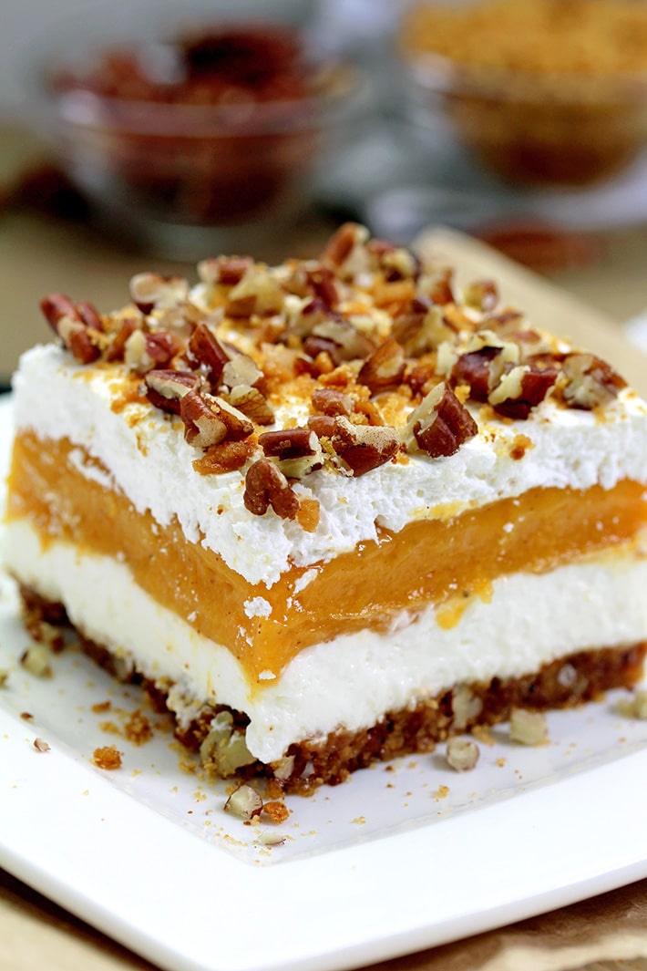 Pumpkin Lush – this fast-made, light, yet delicious creamy dessert, with cheese cream and pumpkin layers, and gingersnap cookie crust, topped with chopped pecans and gingersnap cookie crumbs, will delight all the pumpkin lovers.