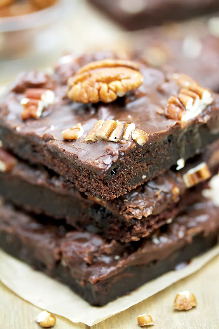 Texas Sheet Cake is thin, super moist chocolate cake, topped with warm chocolate frosting and pecans