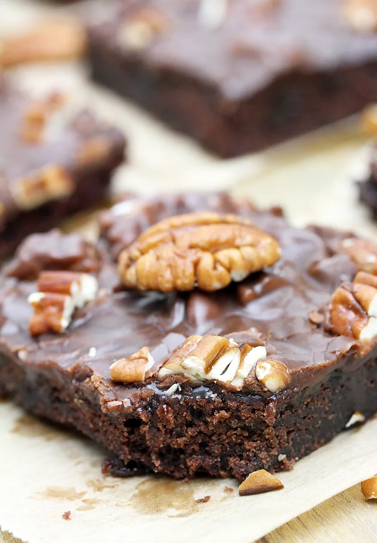 Texas Sheet Cake is thin, super moist chocolate cake, topped with warm chocolate frosting and pecans