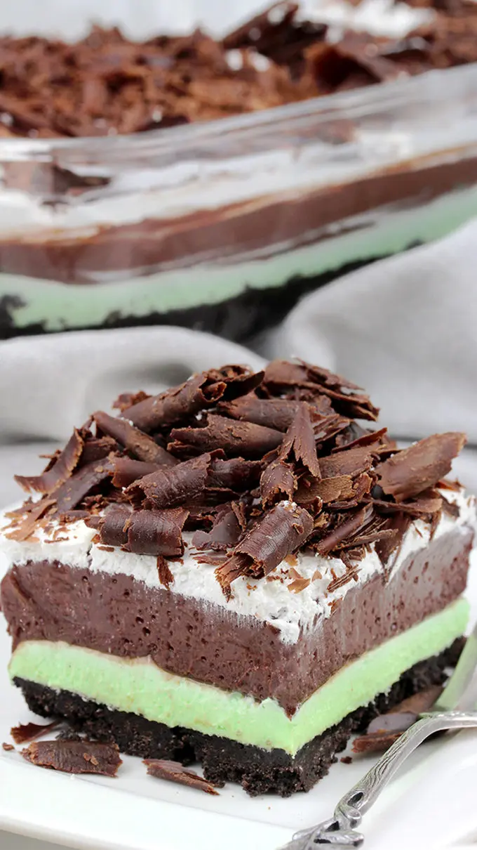 Mint Chocolate Lasagna easy no-bake dessert with layers of Oreo crust, Mint cream cheese, Chocolate pudding, Whipping Cream and Chocolate Curls on top.