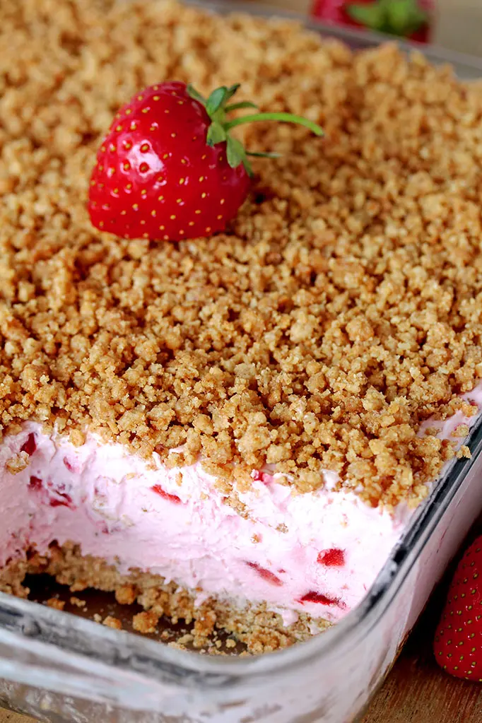 Easy Frozen Strawberry Dessert a perfect spring and summer dessert for all strawberry fans. This refreshing, creamy, frozen dessert made with fresh strawberries and a crunchy graham cracker layer, topped with graham cracker crumbs is very quick and easy to prepare.