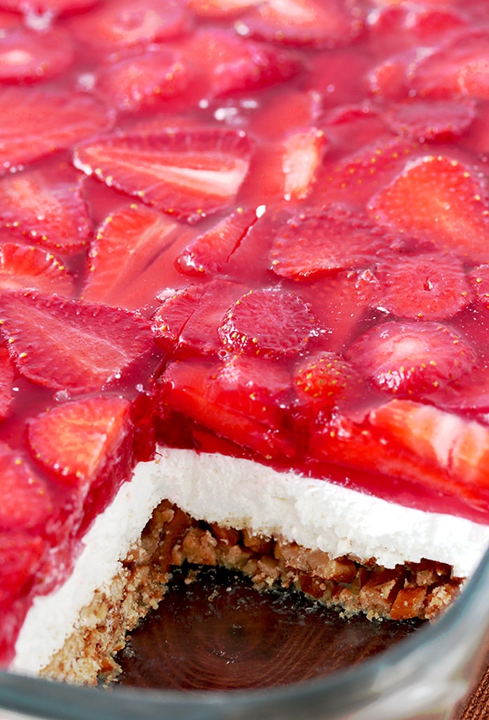 Strawberry Jello Pretzel Salad is a very tasty, old fashioned dessert that is so easy to prepare and that everyone loves. It consists of three different layers. The first one is made of crushed pretzels, sugar and melted butter and it´s baked for 10 minutes. Then, the second layer made of cream cheese, sugar and cool whip comes. For the third layer you will need strawberries, strawberry jello and water.