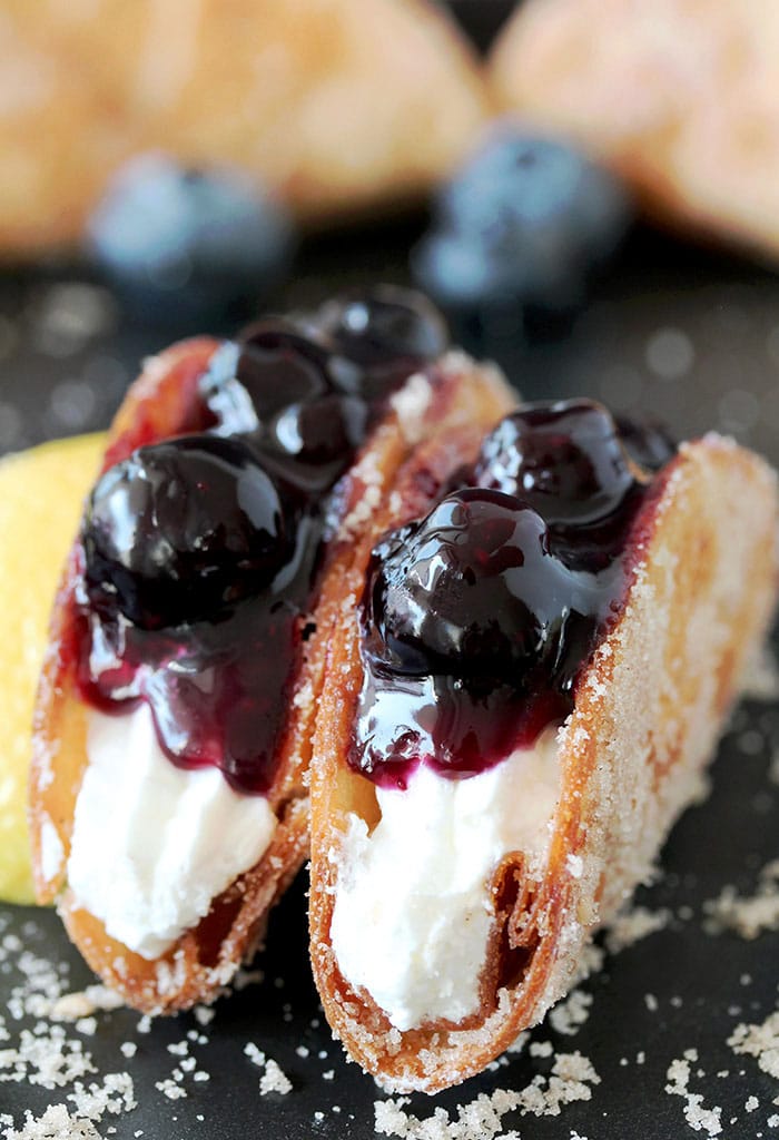 Blueberry Cheesecake Tacos – this is a recipe for very tasty dessert tacos. If you ask me, crunchy tortilla shells, filled with cheesecake filling and topped with homemade blueberry sauce make a perfect dessert