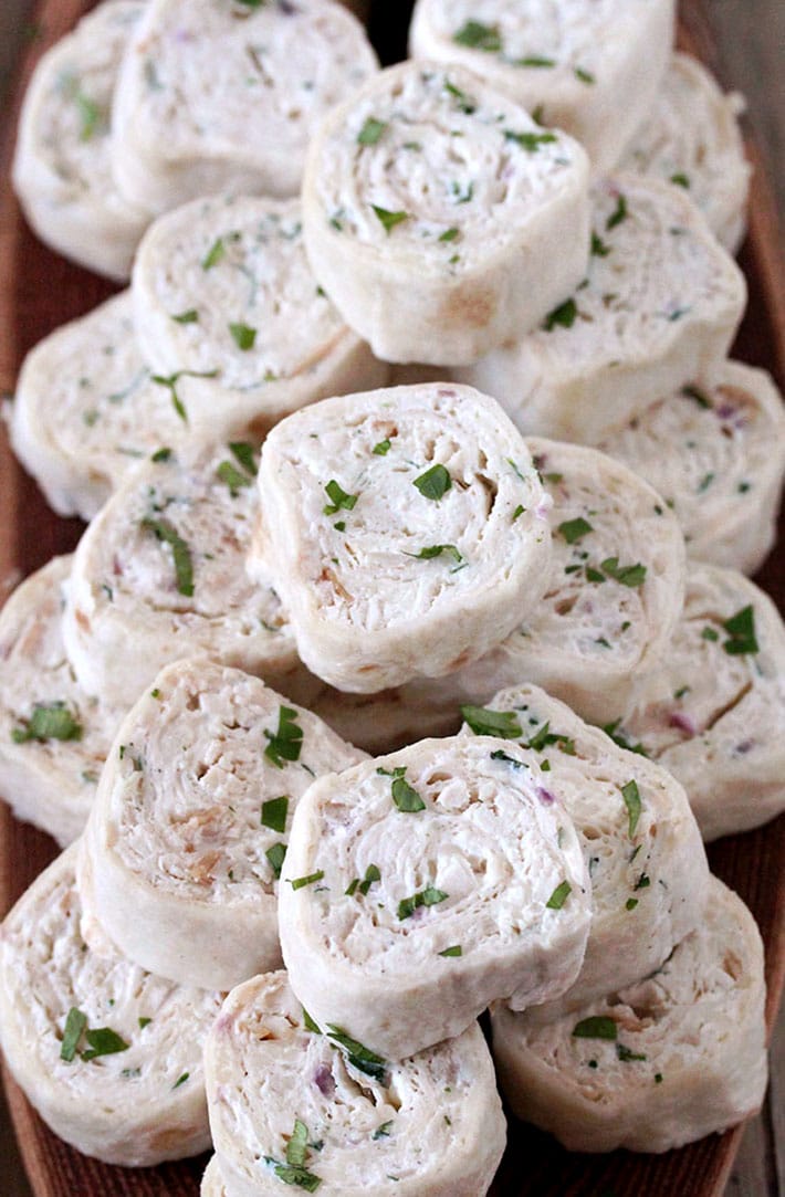 Creamy Chicken Tortilla Pinwheels – these delicious, quick and easy appetizer bites are actually tortillas filled with cream cheese, sour cream, mozzarella, chicken, onion and cilantro, seasoned with black pepper and garlic, then rolled up and sliced
