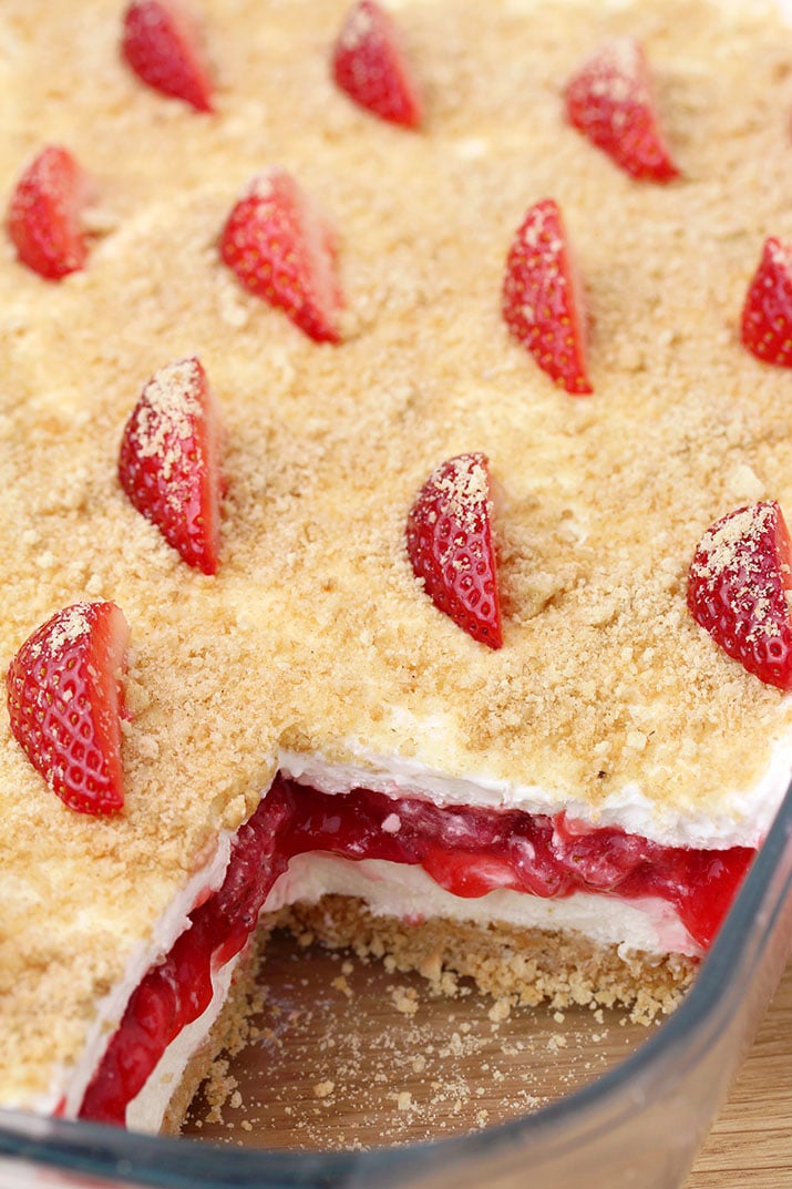 Strawberry Yum Yum – this quick and easy recipe, for no bake, layered dessert will surely become one of your favorites. What makes this cake truly delicious is graham cracker layer, followed by cheesecake, and then strawberry layer, another cheesecake and all is topped with graham cracker crumbs.