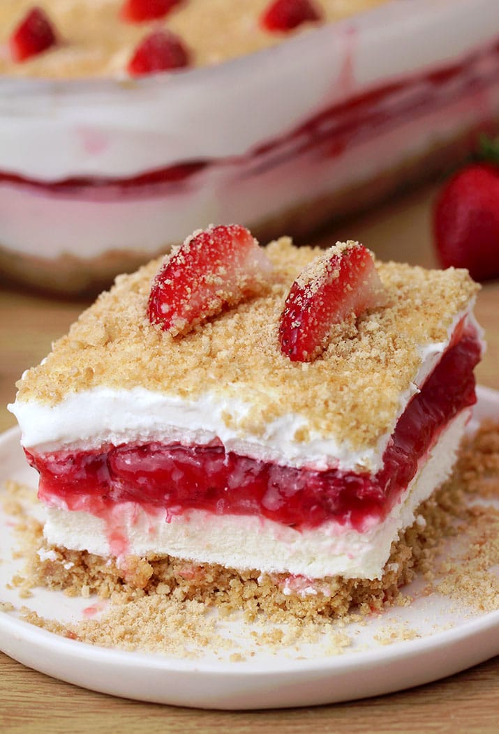 Strawberry Yum Yum – this quick and easy recipe, for no bake, layered dessert will surely become one of your favorites. What makes this cake truly delicious is graham cracker layer, followed by cheesecake, and then strawberry layer, another cheesecake and all is topped with graham cracker crumbs
