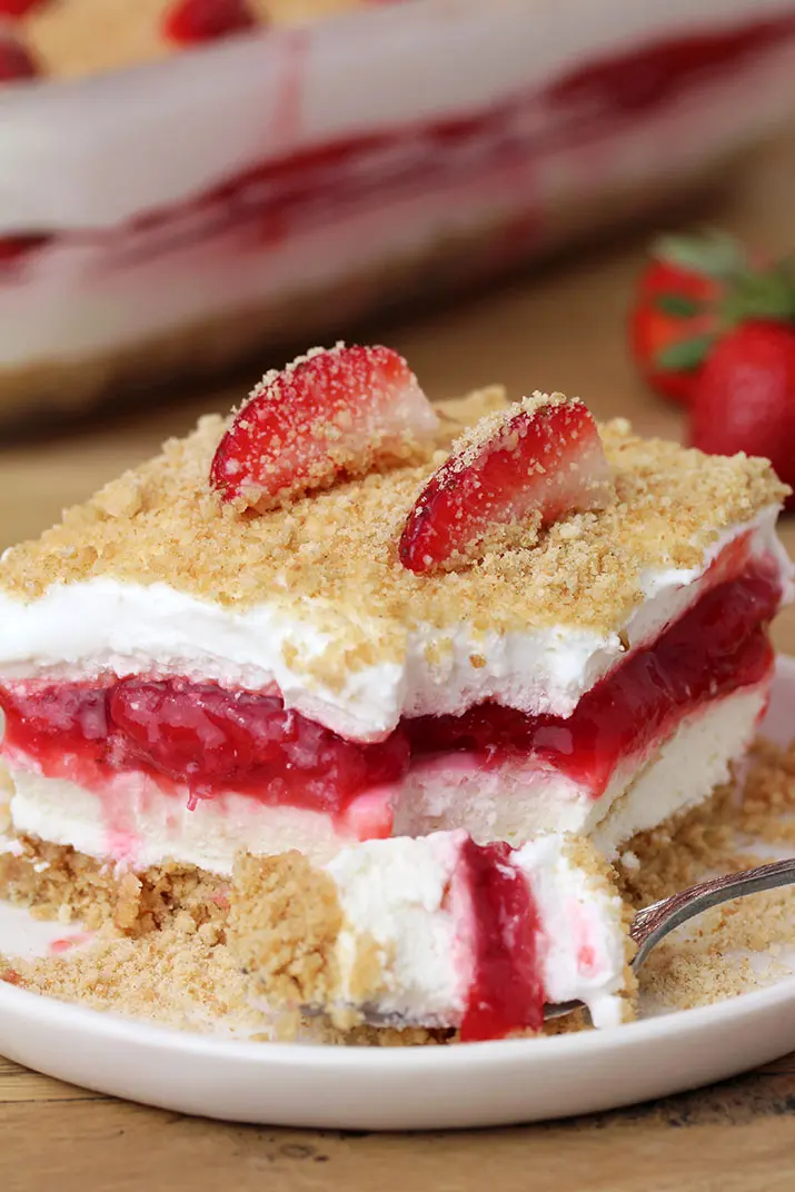 Strawberry Yum Yum – this quick and easy recipe, for no bake, layered dessert will surely become one of your favorites. What makes this cake truly delicious is graham cracker layer, followed by cheesecake, and then strawberry layer, another cheesecake and all is topped with graham cracker crumbs.