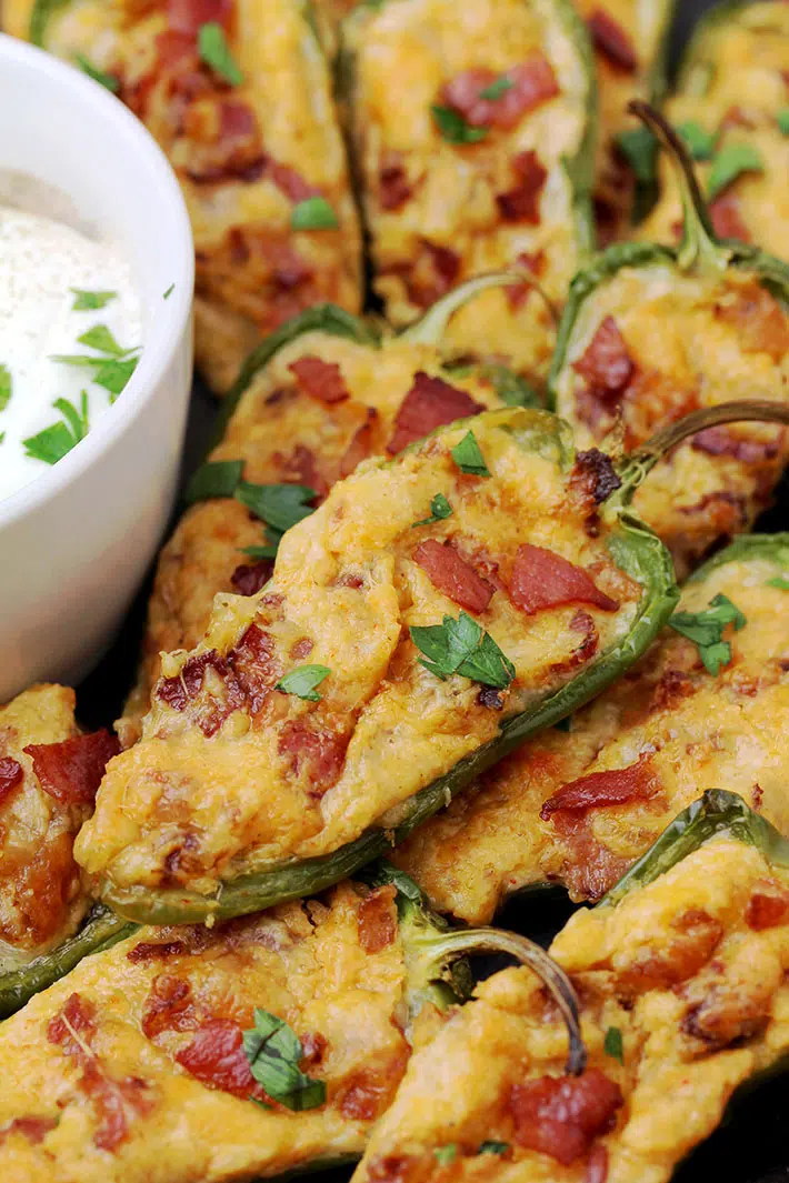 Jalapeno Poppers – homemade, oven baked jalapeno peppers cut in half and filled with the mixture of cream cheese, mozzarella and cheddar cheese, crunchy bacon and spices make a ultimate party appetizer or a snack.