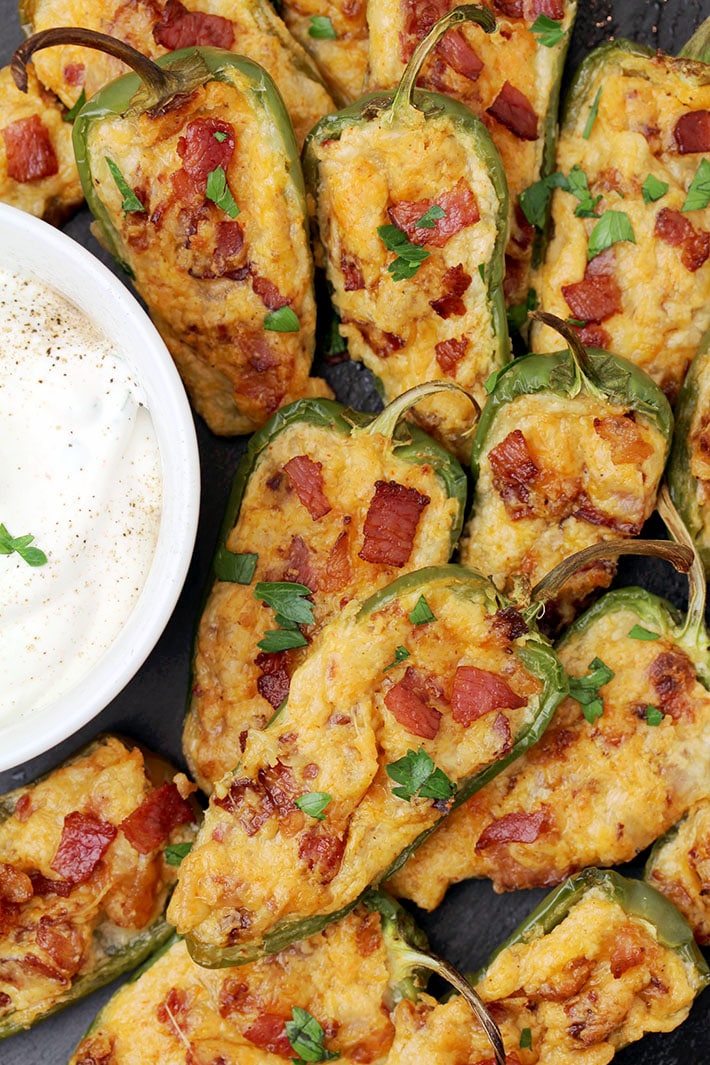 Jalapeno Poppers – homemade, oven baked jalapeno peppers cut in half and filled with the mixture of cream cheese, mozzarella and cheddar cheese, crunchy bacon and spices make a ultimate party appetizer or a snack.