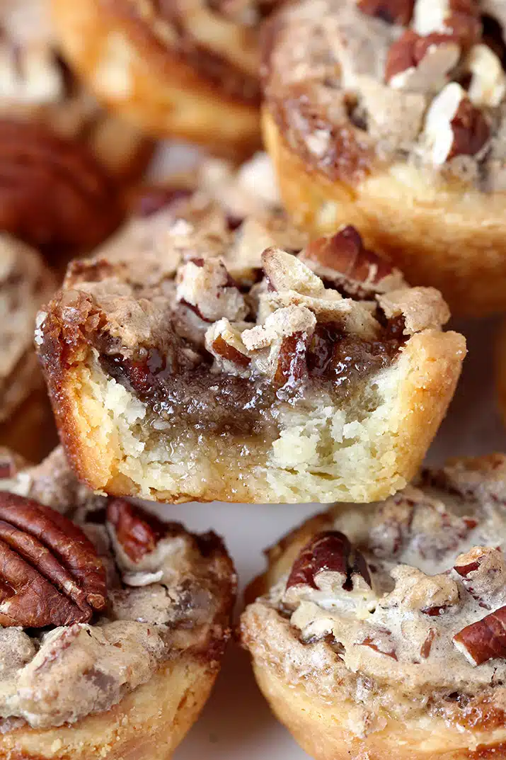 Pecan Tassies – dessert bites just perfect for Thanksgiving or Christmas. They are often called cookies because of their size, but they are closest to being called pecan pies. The dough is made of cream cheese, butter and flour mixture and they are filled with a sweet filling made of pecans, brown sugar, butter, eggs, cinnamon and vanilla. This buttery dough is unbelievably soft and makes a perfect combination with sweet filling and crunchy pecans. 