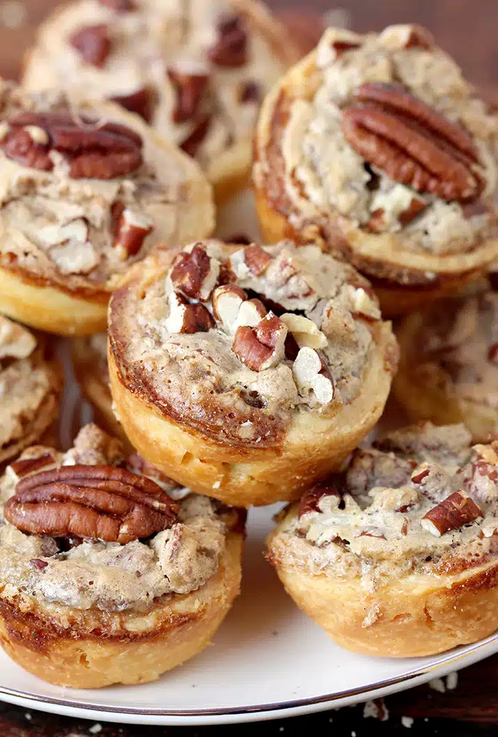 Pecan Tassies – dessert bites just perfect for Thanksgiving or Christmas. They are often called cookies because of their size, but they are closest to being called pecan pies. The dough is made of cream cheese, butter and flour mixture and they are filled with a sweet filling made of pecans, brown sugar, butter, eggs, cinnamon and vanilla. This buttery dough is unbelievably soft and makes a perfect combination with sweet filling and crunchy pecans. 