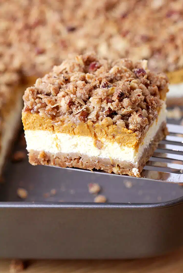 Pumpkin Cheesecake Bars – this holiday dessert with graham crackers and pecan crust, classical creamy cheesecake layer, pumpkin cheesecake layer and streusel topping with oats and pecans will fulfill all your expectations. It’s a perfect Thanksgiving dessert. 