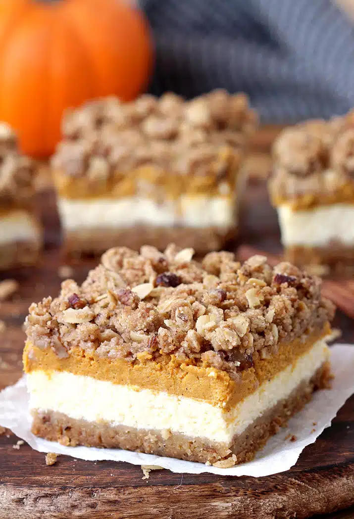 Pumpkin Cheesecake Bars – this holiday dessert with graham crackers and pecan crust, classical creamy cheesecake layer, pumpkin cheesecake layer and streusel topping with oats and pecans will fulfill all your expectations. It’s a perfect Thanksgiving dessert.