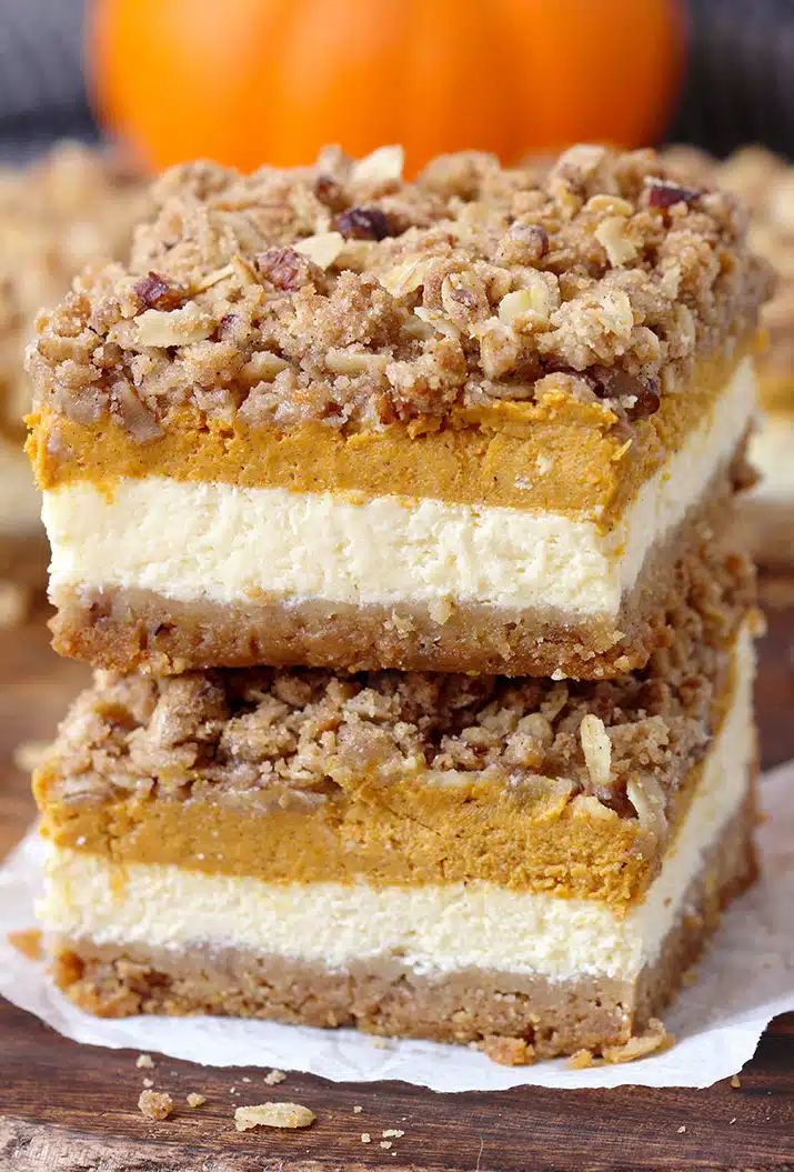 Pumpkin Cheesecake Bars – this holiday dessert with graham crackers and pecan crust, classical creamy cheesecake layer, pumpkin cheesecake layer and streusel topping with oats and pecans will fulfill all your expectations. It’s a perfect Thanksgiving dessert.