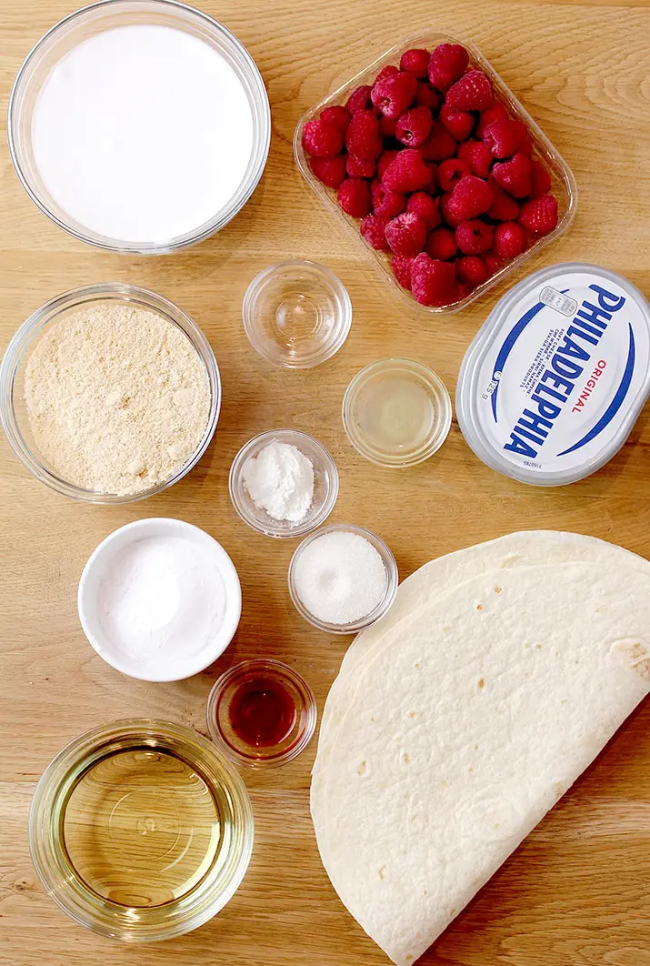 Raspberry Cheesecake Tacos – crunchy tortilla shells, creamy cheesecake filling, topped with raspberry sauce and fresh raspberries on top make this amazing dessert. These incredible bites are perfect for holidays, parties and other events. 