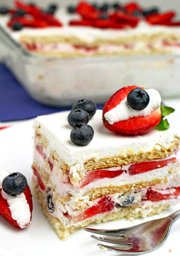 Incredible Icebox Cake with layers of heavy cream, cream cheese, fresh blueberries and strawberries and lemon juice.. some of my favorite fruity flavors.
