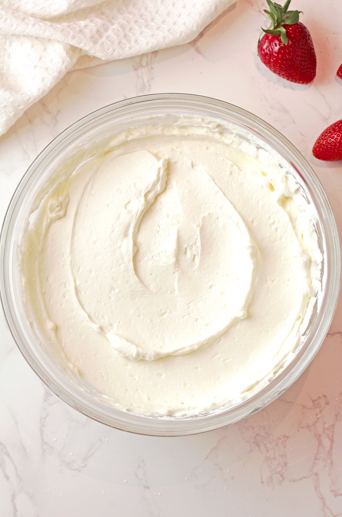 Folding Cool Whip into creamy mixture for light and fluffy fluff salad texture.