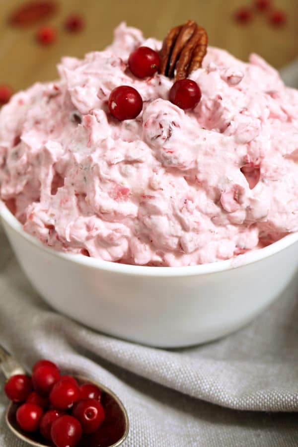 This salad is a perfect dessert for Thanksgiving Dinner or New Year's Eve feast. Cranberry Cheesecake Fluff Salad is quick, simple and easy to prepare.