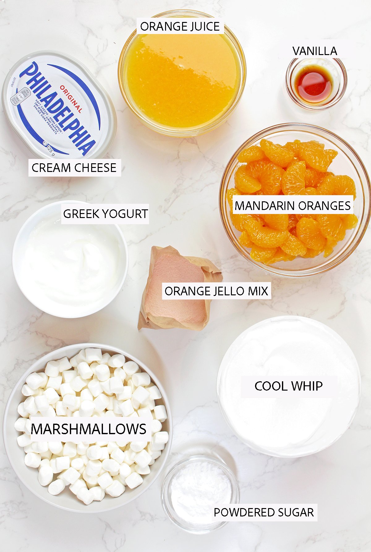 Creamsicle Orange Cheesecake Fluff Salad is an easy no bake orange dessert made with cream cheese, orange Jello, Cool Whip and mandarin oranges for a light, fluffy cheesecake salad.