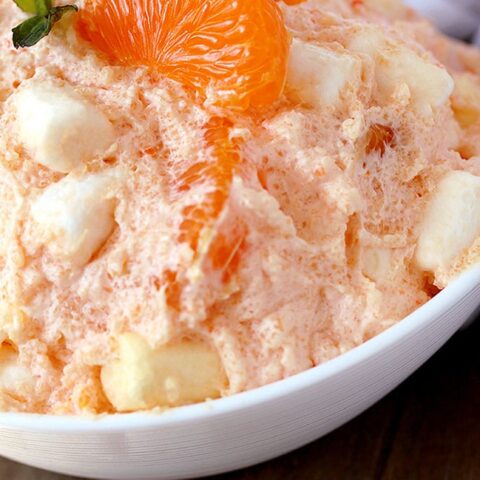 Creamsicle Orange Cheesecake Fluff Salad – this refreshing quick and easy salad is one of my favorite desserts. Cream cheese, Greek yogurt, orange juice and cool whip make this salad so creamy. Marshmallow melts in your mouth and mandarin oranges make it refreshing.