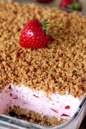 This refreshing, creamy, frozen dessert made with fresh strawberries and a crunchy graham cracker layer, topped with graham cracker crumbs is very quick and easy to prepare.