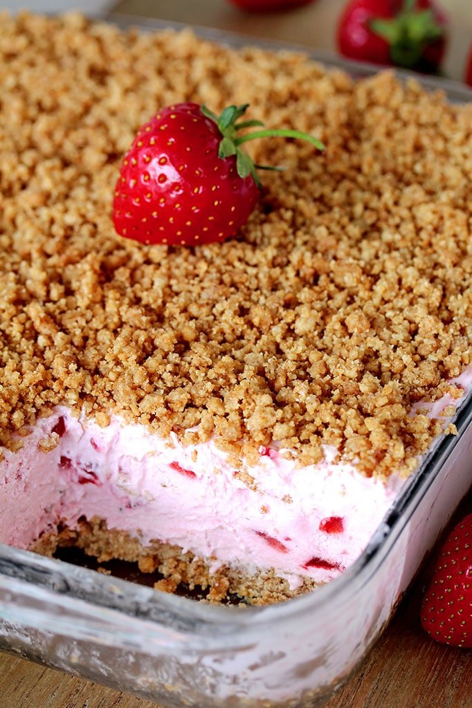 Easy Frozen Strawberry Dessert a perfect spring and summer dessert for all strawberry fans. This refreshing, creamy, frozen dessert made with fresh strawberries and a crunchy graham cracker layer, topped with graham cracker crumbs is very quick and easy to prepare