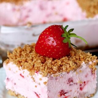 Easy Frozen Strawberry Dessert a perfect spring and summer dessert for all strawberry fans. This refreshing, creamy, frozen dessert made with fresh strawberries and a crunchy graham cracker layer, topped with graham cracker crumbs is very quick and easy to prepare.