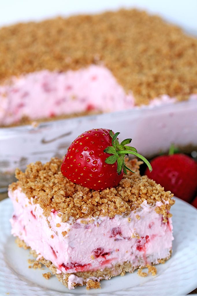 Easy Frozen Strawberry Dessert a perfect spring and summer dessert for all strawberry fans. This refreshing, creamy, frozen dessert made with fresh strawberries and a crunchy graham cracker layer, topped with graham cracker crumbs is very quick and easy to prepare.