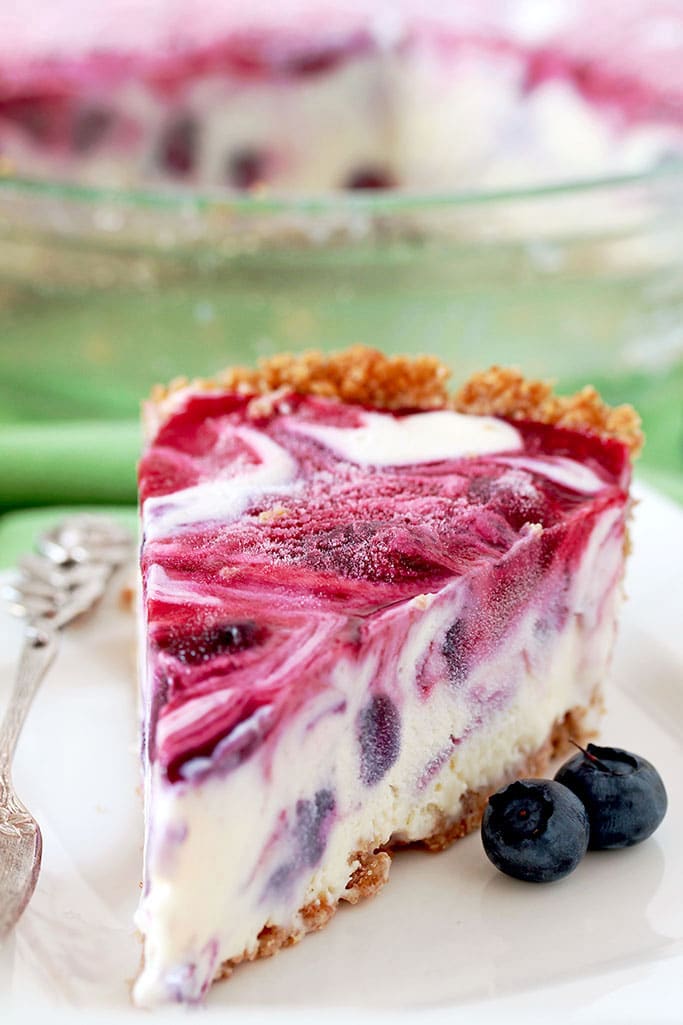 Very Berry Frozen Cream Pie is a dessert with fresh season blueberries and raspberries, just perfect refreshment for hot summer days. If you like ice cream, especially fruit, you will love this pie. This is one of my favorite summer desserts. Graham cracker pie crust, frozen cream, swirls with homemade blueberry and raspberry filling… Pure perfection, if you ask me.