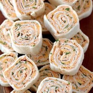 Taco Tortilla Roll Ups this quick and easy party appetizer filled with cream cheese, sour cream, chicken, cheddar cheese, taco seasoning, taco sauce and parsley is perfect for every holiday or a party.