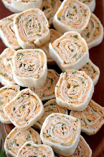 Taco Tortilla Roll Ups this quick and easy party appetizer filled with cream cheese, sour cream, chicken, cheddar cheese, taco seasoning, taco sauce and parsley is perfect for every holiday or a party.