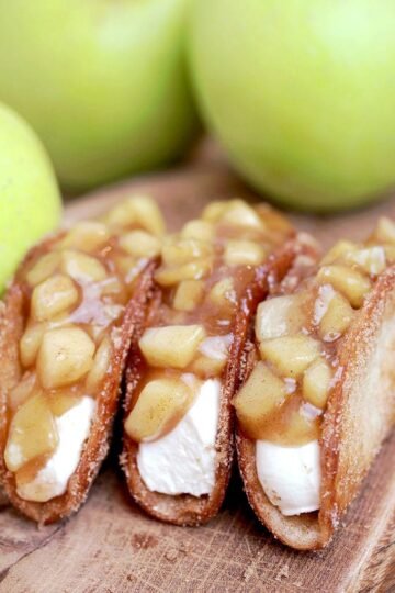 Apple Cheesecake Tacos - crunchy cinnamon sugar tortilla shells, filled with cheesecake filling and covered with homemade apple pie filling are simply perfect. This very tasty dessert is ideal for upcoming fall days.