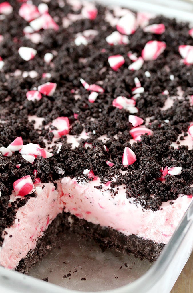 Easy Frozen Peppermint Dessert – this quick and easy holiday treat is made of peppermint candies, cream cheese, whipped cream and sweetened condensed milk, it has an Oreo layer and is topped with crushed peppermint candies and Oreos. 