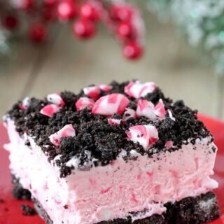 Easy Frozen Peppermint Dessert – this quick and easy holiday treat is made of peppermint candies, cream cheese, whipped cream and sweetened condensed milk, it has an Oreo layer and is topped with crushed peppermint candies and Oreos.