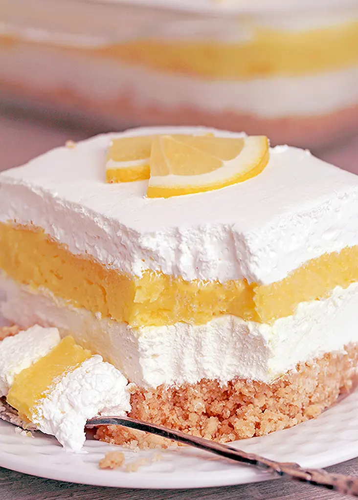Easy Lemon Cheesecake Lasagna is a quick and simple layered dessert. What makes it so tasty is a Golden Oreo base, cheesecake layer, lemon pudding layer and whipped topping on top