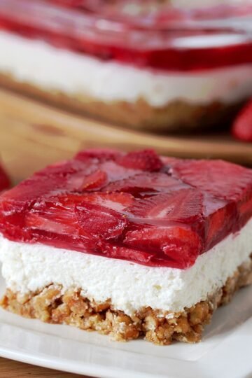 Strawberry Jello Pretzel Salad is a very tasty, old fashioned dessert that is so easy to prepare and that everyone loves. It consists of three different layers. The first one is made of crushed pretzels, sugar and melted butter and it´s baked for 10 minutes. Then, the second layer made of cream cheese, sugar and cool whip comes. For the third layer you will need strawberries, strawberry jello and water