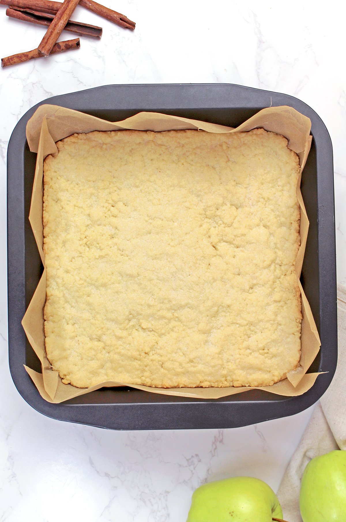 Partially baked shortbread crust ready for the apple filling.