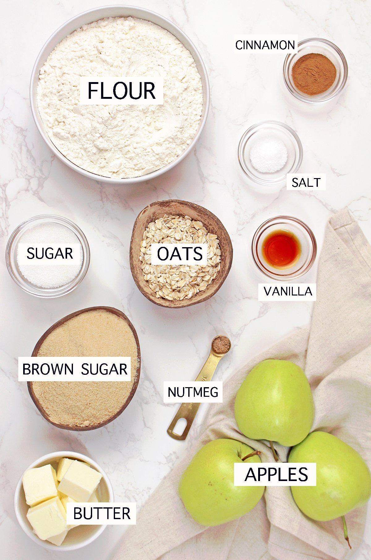 Ingredients for Apple Crisp Bars including apples, flour, butter, oats, brown sugar, cinnamon, vanilla, and nutmeg.