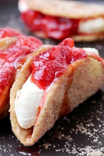 Strawberry Cheesecake Tacos – crunchy cinnamon and sugar tortilla shells, filled with cheesecake and topped with homemade strawberry sauce are perfect bites for every occasion. They are so easy to make, they look great and taste even better.