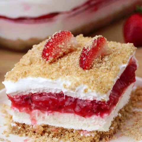 Strawberry Yum Yum – this quick and easy recipe, for no bake, layered dessert will surely become one of your favorites. What makes this cake truly delicious is graham cracker layer, followed by cheesecake, and then strawberry layer, another cheesecake and all is topped with graham cracker crumbs