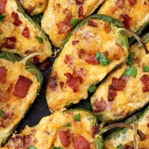 Jalapeno Poppers – homemade, oven baked jalapeno peppers cut in half and filled with the mixture of cream cheese, mozzarella and cheddar cheese, crunchy bacon and spices make a perfect party appetizer or a snack.