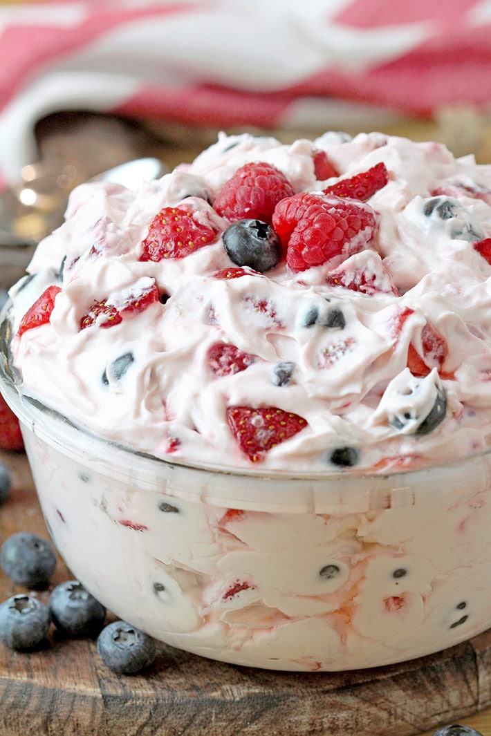 Red White and Blue Cheesecake Salad – this perfect summer salad full of fresh blueberries, strawberries and raspberries will surely sweep you off your feet. It’s quick and easy to make, refreshing and sweet at the same time. Juicy fruits combined with cheesecake filling is a winning combination. If you make this salad for the next potluck or BBQ, you’ll be surprised how soon the bowl will be empty. Red white and blue cheesecake salad can be a hit on the July 4th celebration party. It’s more of a dessert than a salad and some like it as a snack or even breakfast.