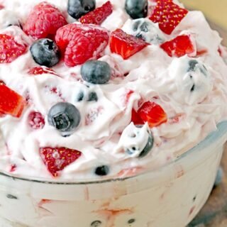 Red White and Blue Cheesecake Salad – this perfect summer salad full of fresh blueberries, strawberries and raspberries will surely sweep you off your feet. It’s quick and easy to make, refreshing and sweet at the same time. Juicy fruits combined with cheesecake filling is a winning combination. If you make this salad for the next potluck or BBQ, you’ll be surprised how soon the bowl will be empty. Red white and blue cheesecake salad can be a hit on the July 4th celebration party. It’s more of a dessert than a salad and some like it as a snack or even breakfast.