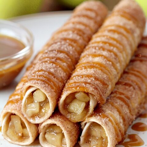 Caramel Apple Pie Taquitos – tortillas filled with apple pie filling, rolled in sugar and cinnamon, oven baked and drizzled with caramel sauce are real fall dessert. This quick and easy recipe will be a hit this fall. Caramel Apple Pie Taquitos can be served for breakfast, snack or a dessert.
