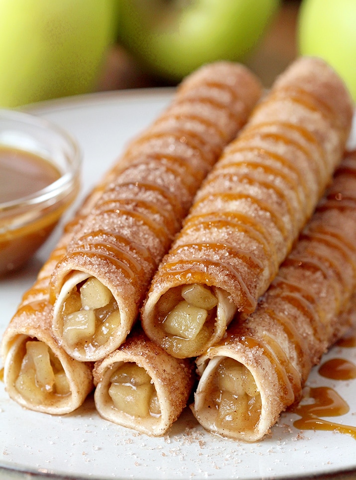 Caramel Apple Pie Taquitos – tortillas filled with apple pie filling, rolled in sugar and cinnamon, oven baked and drizzled with caramel sauce are real fall dessert. This quick and easy recipe will be a hit this fall. Caramel Apple Pie Taquitos can be served for breakfast, snack or a dessert. 