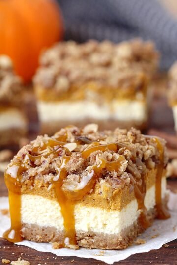 Pumpkin Cheesecake Bars – this holiday dessert with graham crackers and pecan crust, classical creamy cheesecake layer, pumpkin cheesecake layer and streusel topping with oats and pecans will fulfill all your expectations. It’s a perfect Thanksgiving dessert.